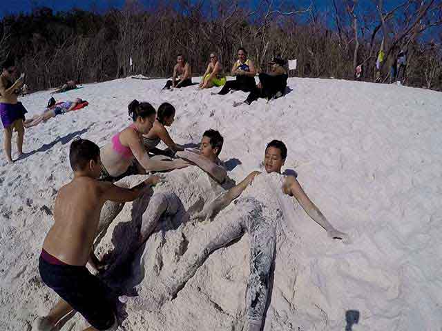 kids getting covered in sand 