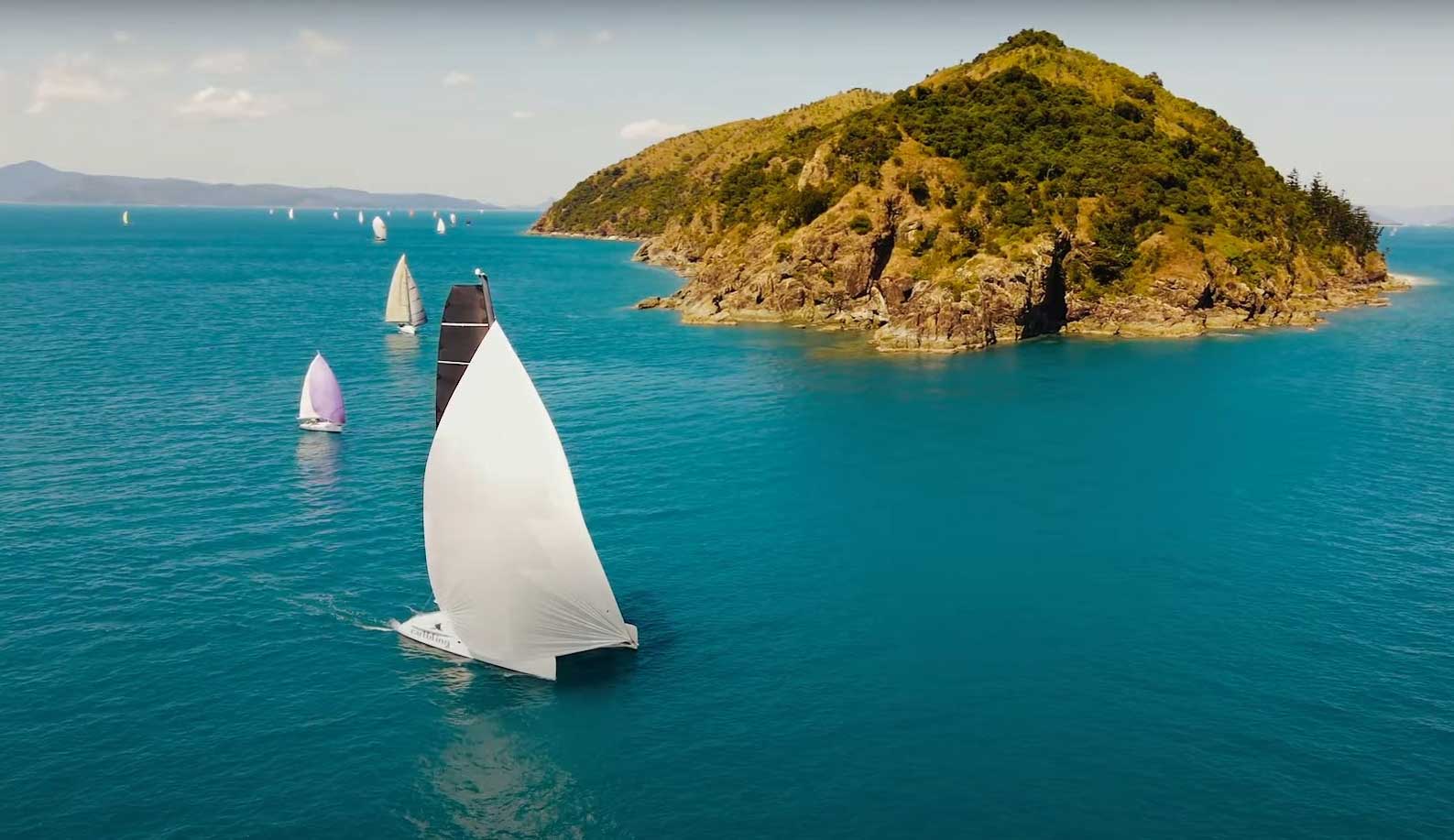 yachts racing around an island offshore of Airlie Beach