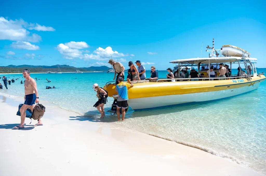 The boat unloading guests at Whitehaven Beach with fold down stairs for beach landings