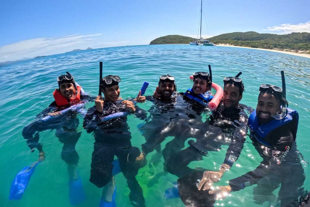 6 men with lifejackets and floatation equipment to help them snorkel in the Whitsundays
