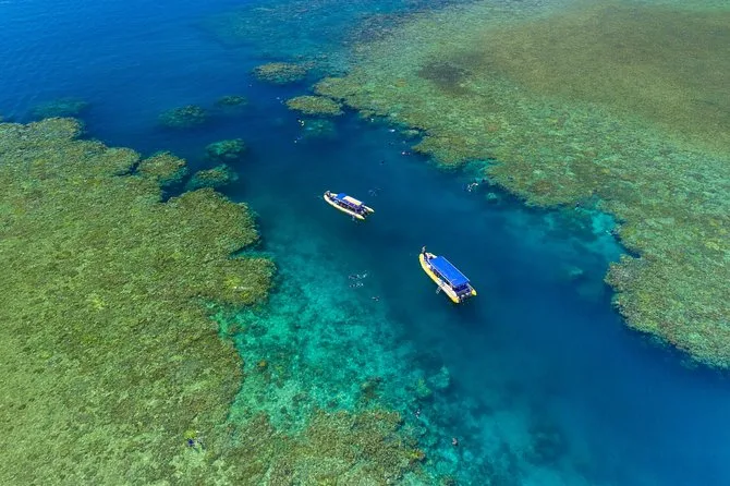 2 Ocean rafting boats surrounded by coral reef