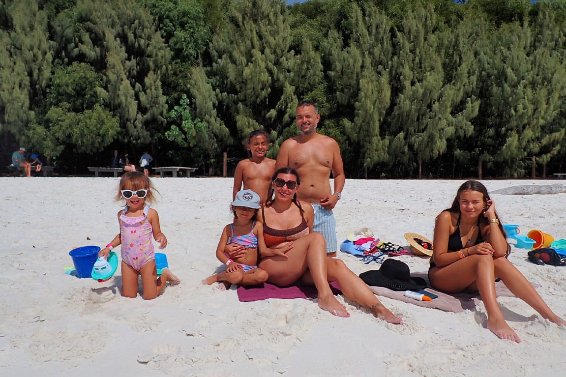 Family relaxing on Whitehaven Beach
